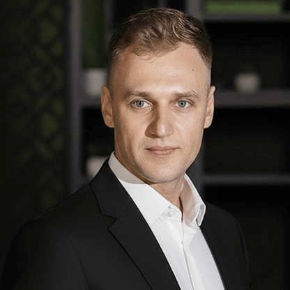Marin, team member at Image Studio, professional portrait wearing light grey pinstripe suit and red tie