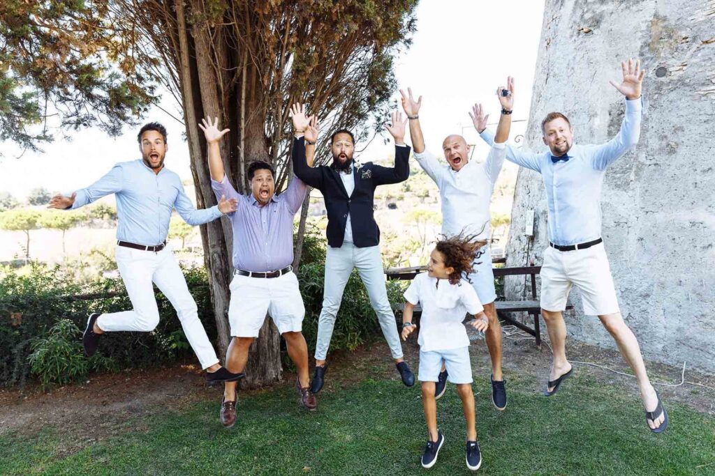 Groomsmen jumping in celebration during a wedding at Borgo di Tragliata near Rome