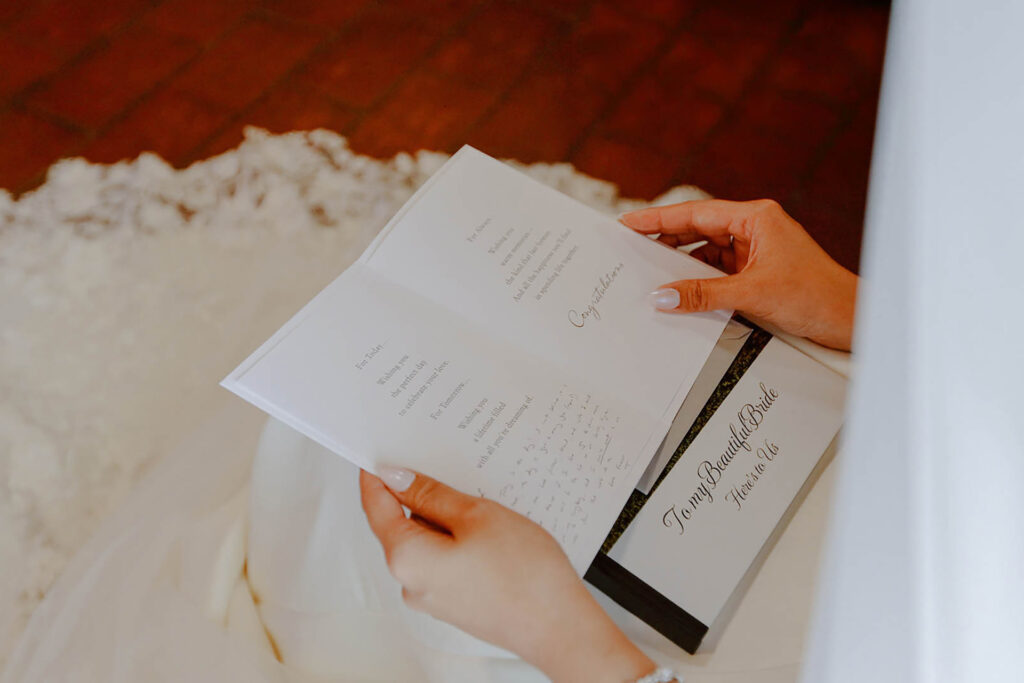 Bride reading an emotional letter on her wedding morning during bridal preparation