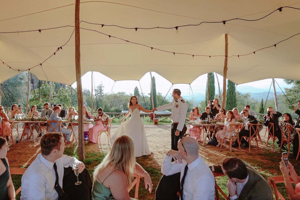 Bride and groom dancing under a reception tent during a wedding at Castello di Ristonchi in Tuscany