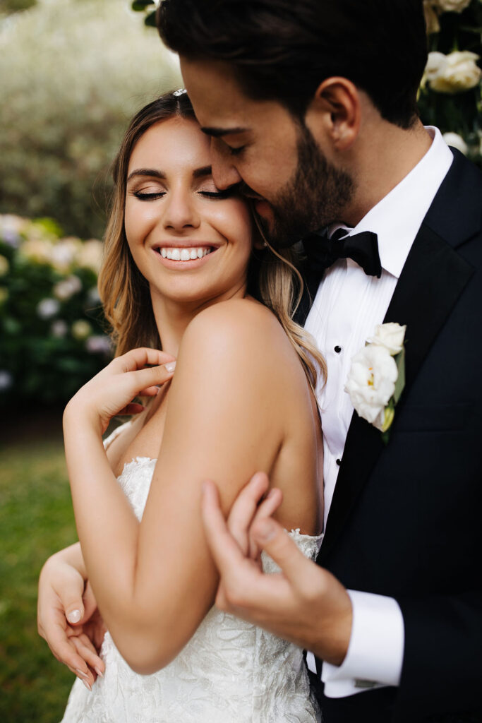 Romantic close-up portrait of bride and groom embracing during a wedding at Castello di Rossino in Lake Como