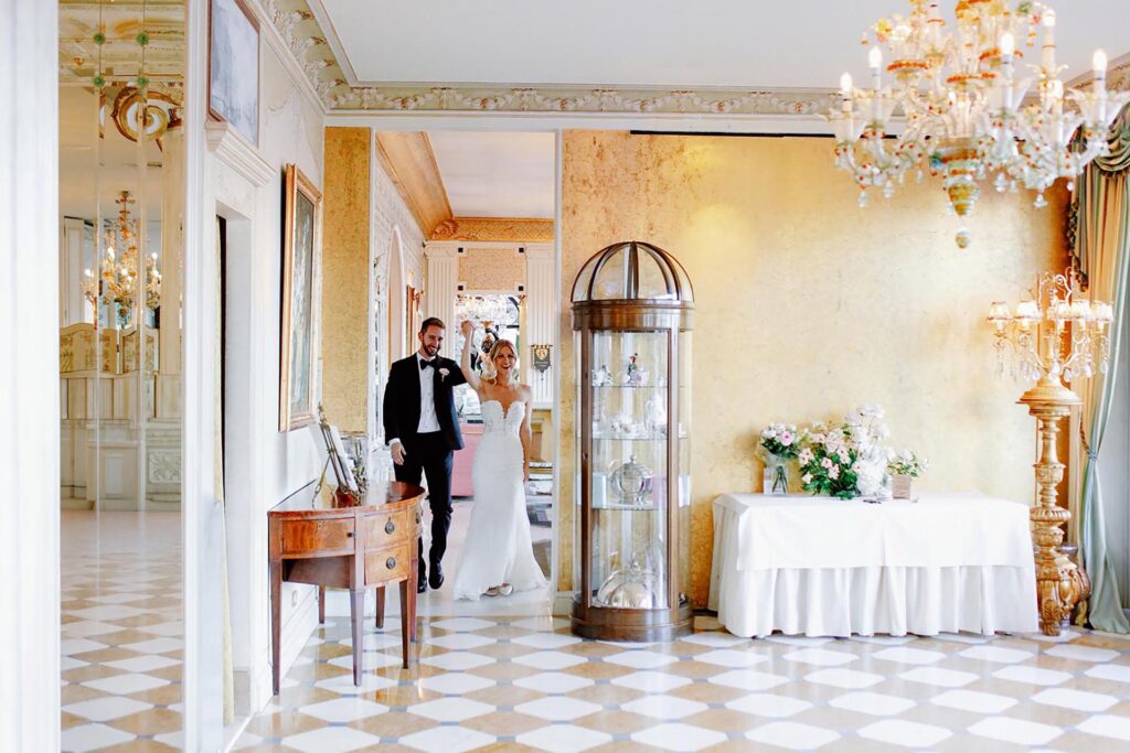 Bride and groom entering a luxury reception hall at Hotel Villa Palazzo Aminta on Lake Maggiore, Italy