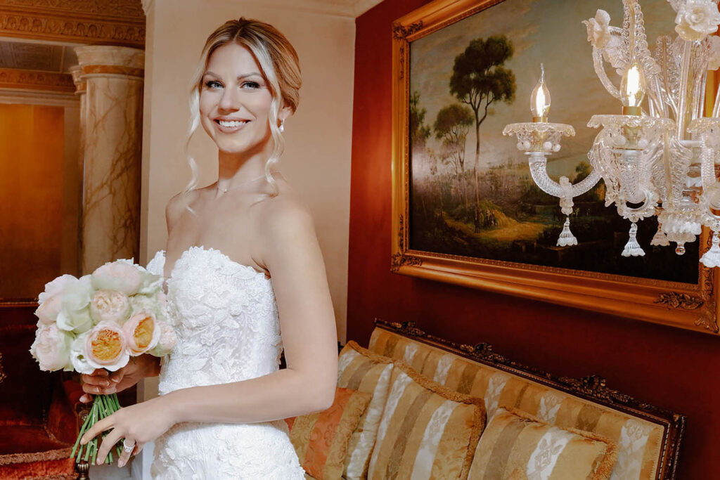 Elegant bride holding a bouquet inside Palazzo Aminta in Lake Maggiore during a luxury Italian wedding