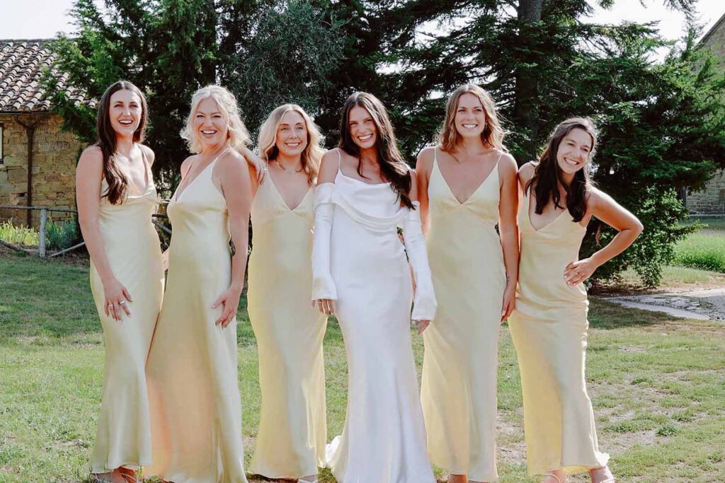 Bride and bridesmaids wearing soft yellow dresses during a luxury destination wedding at Castello di Ristonchi in Tuscany, Italy