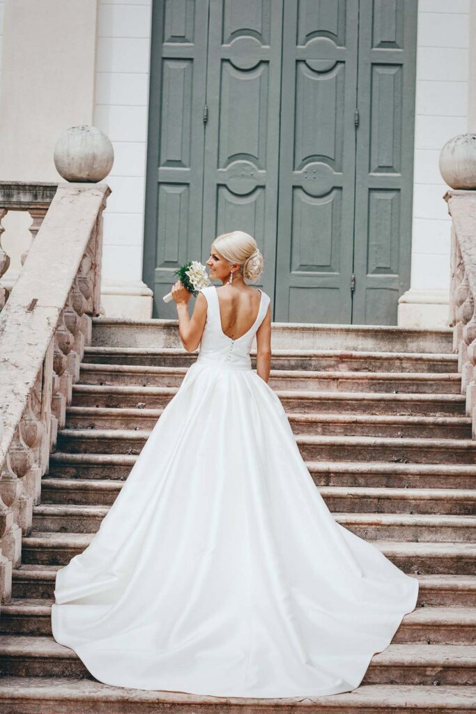 Elegant bride portrait on the staircase of Villa Molin in Padua, Italy during a luxury villa wedding