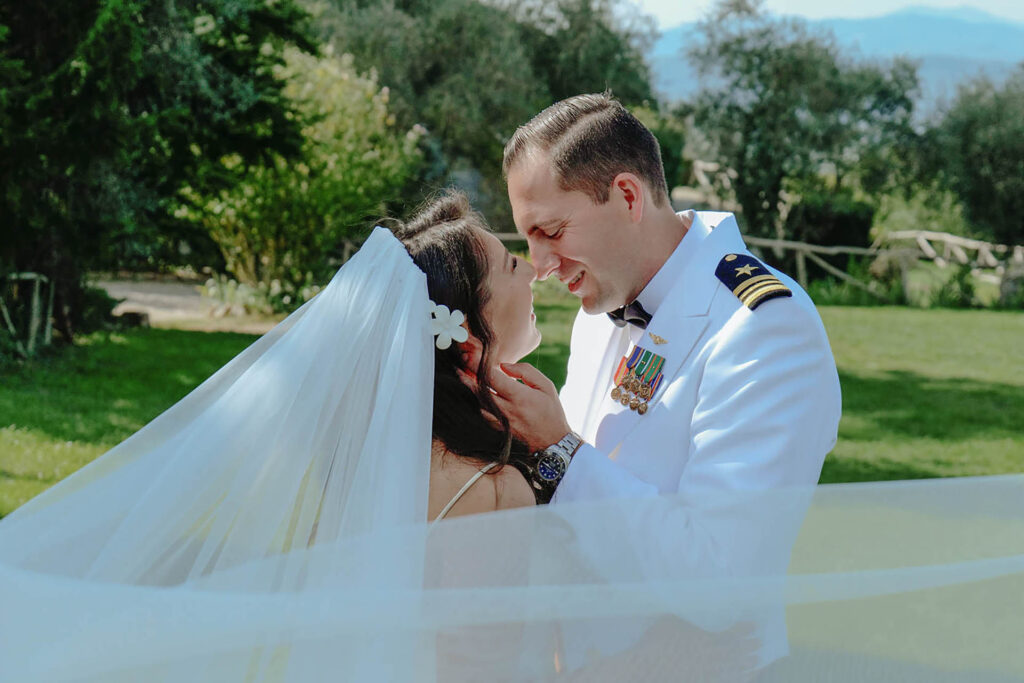 Bride and groom embracing under veil at Castello di Ristonchi in Tuscany