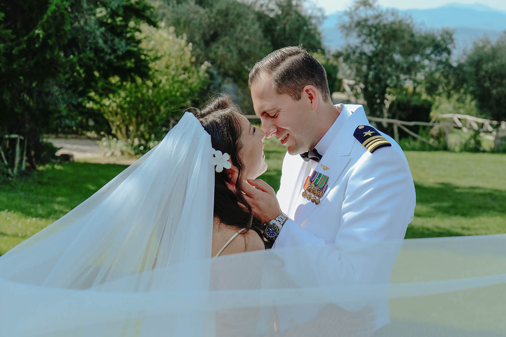 Bride and groom embracing under veil at Castello di Ristonchi in Tuscany