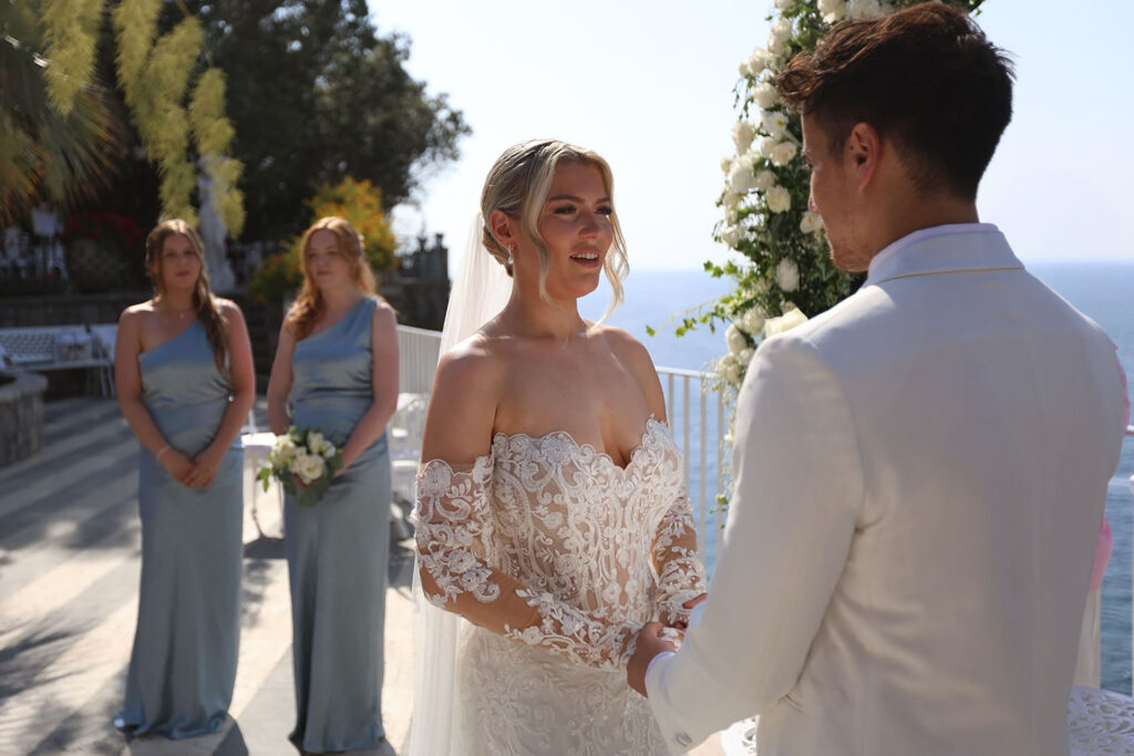 Bride and groom exchanging vows during a seaside wedding ceremony at Villa Antiche Mura in Sorrento, Italy