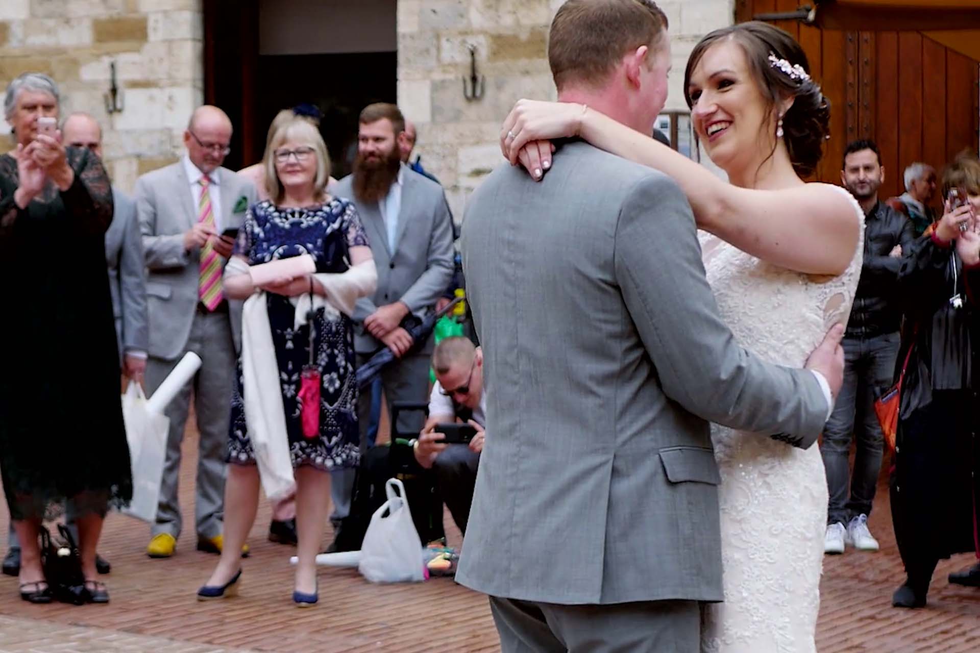 Bride and groom first dance at Tim and Flora wedding in San Gimignano Tuscany surrounded by guests and emotional atmosphere