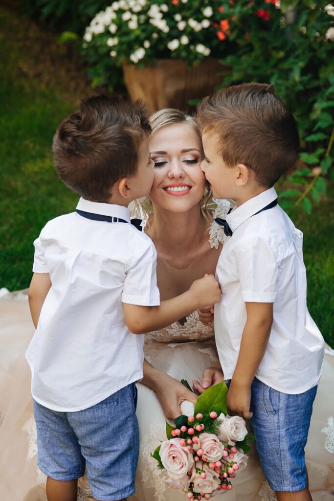 Bride sharing an emotional moment with two young boys during an intimate wedding celebration in Verona, Italy