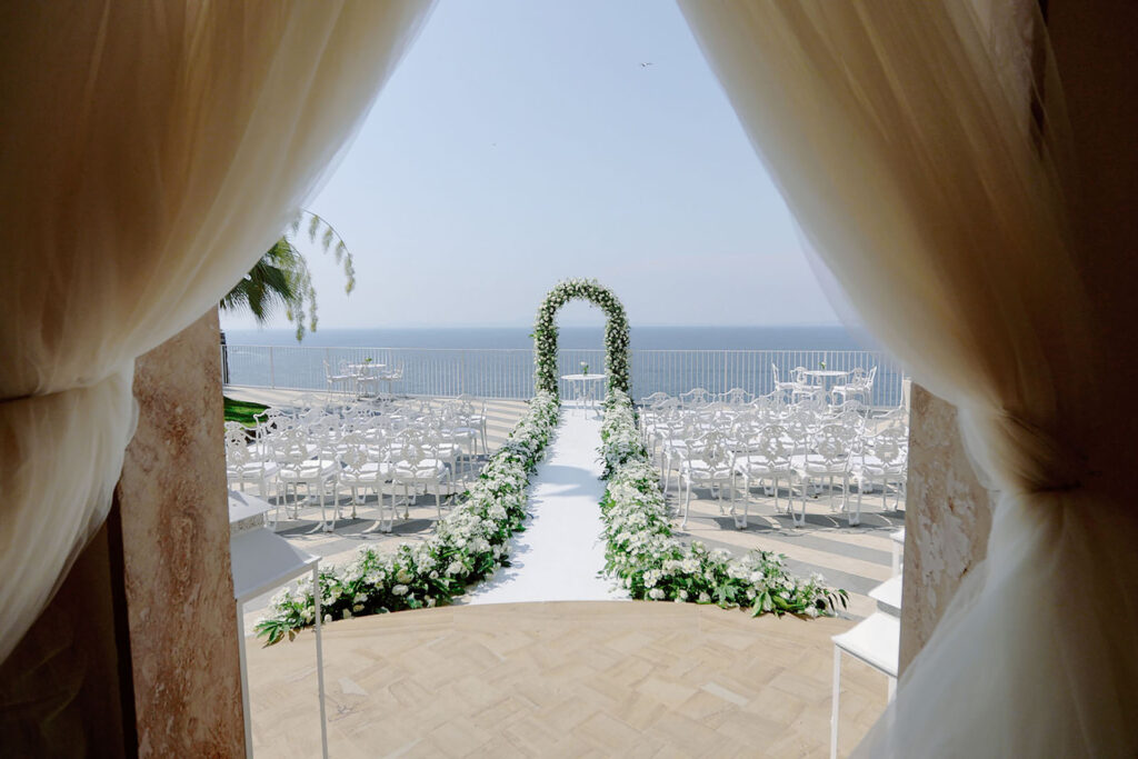 Luxury outdoor wedding ceremony setup at Villa Antiche Mura in Sorrento overlooking the Amalfi Coast sea view