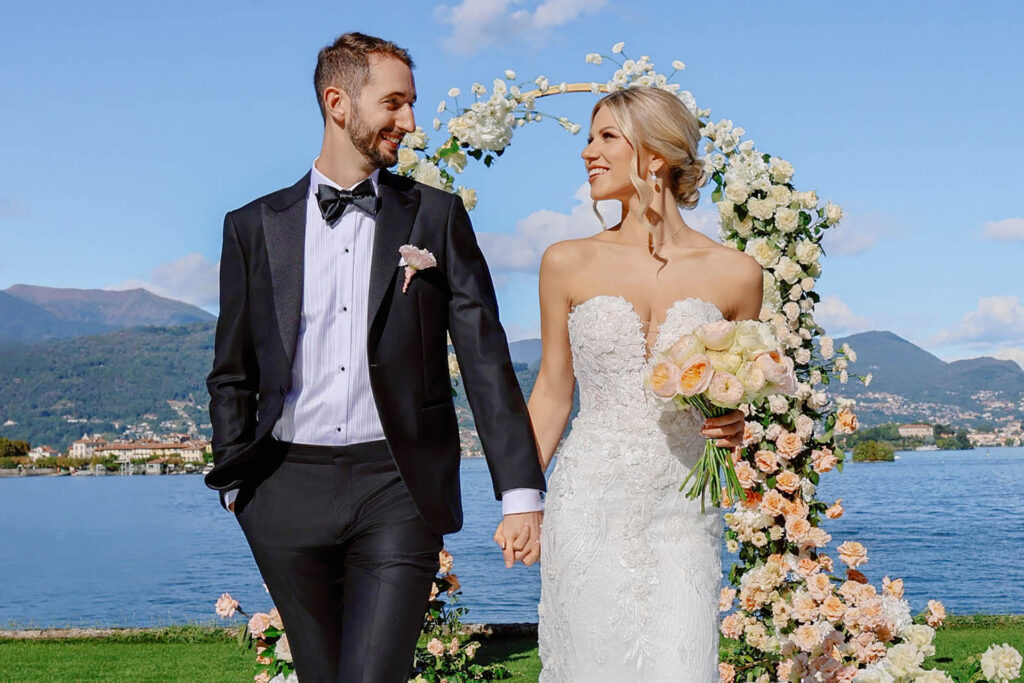 Bride and groom walking hand in hand during a luxury destination wedding ceremony at Villa Antiche Mura in Sorrento, Italy overlooking the Mediterranean Sea