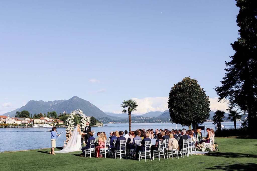 Outdoor wedding ceremony at Villa e Palazzo Aminta on Lake Maggiore with mountain views and floral arch