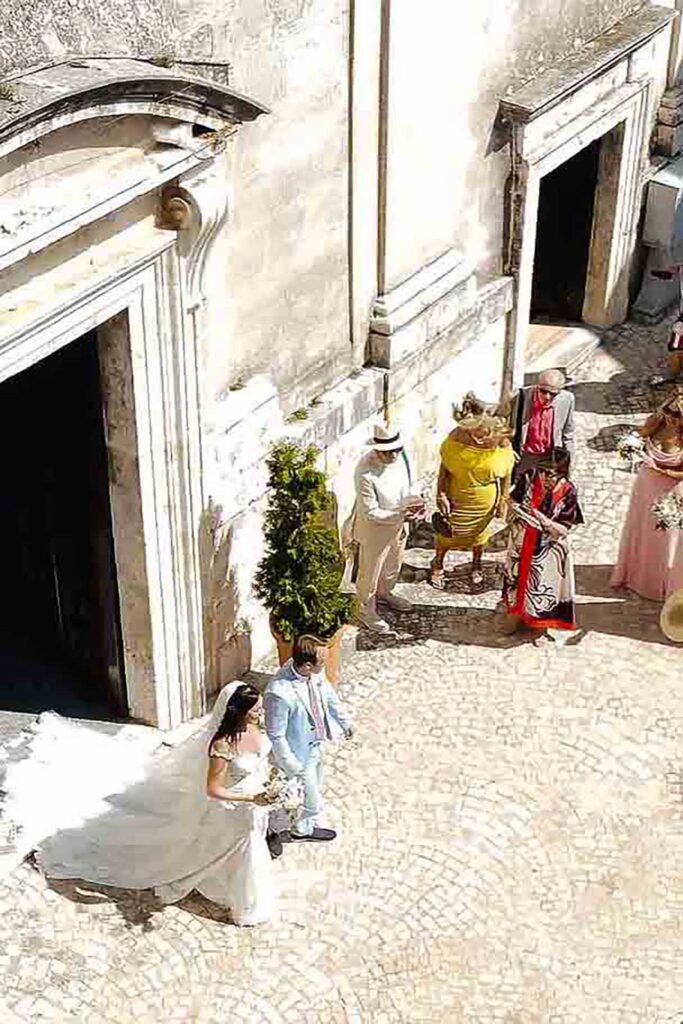 Bride and groom exiting a historic church in Picinisco, Italy after their wedding ceremony
