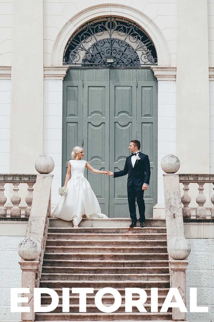 Bride and groom posing on a historic staircase in Venice, Italy during an elegant editorial destination wedding portrait
